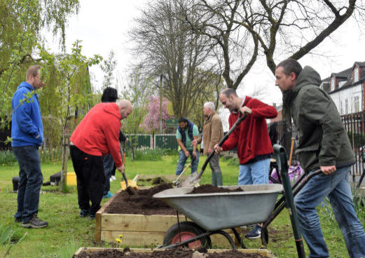 group of service users taking part in a gardening session in north manchester