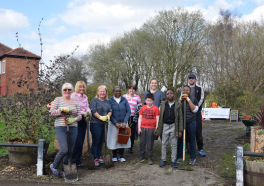 group of people in community garden manchester